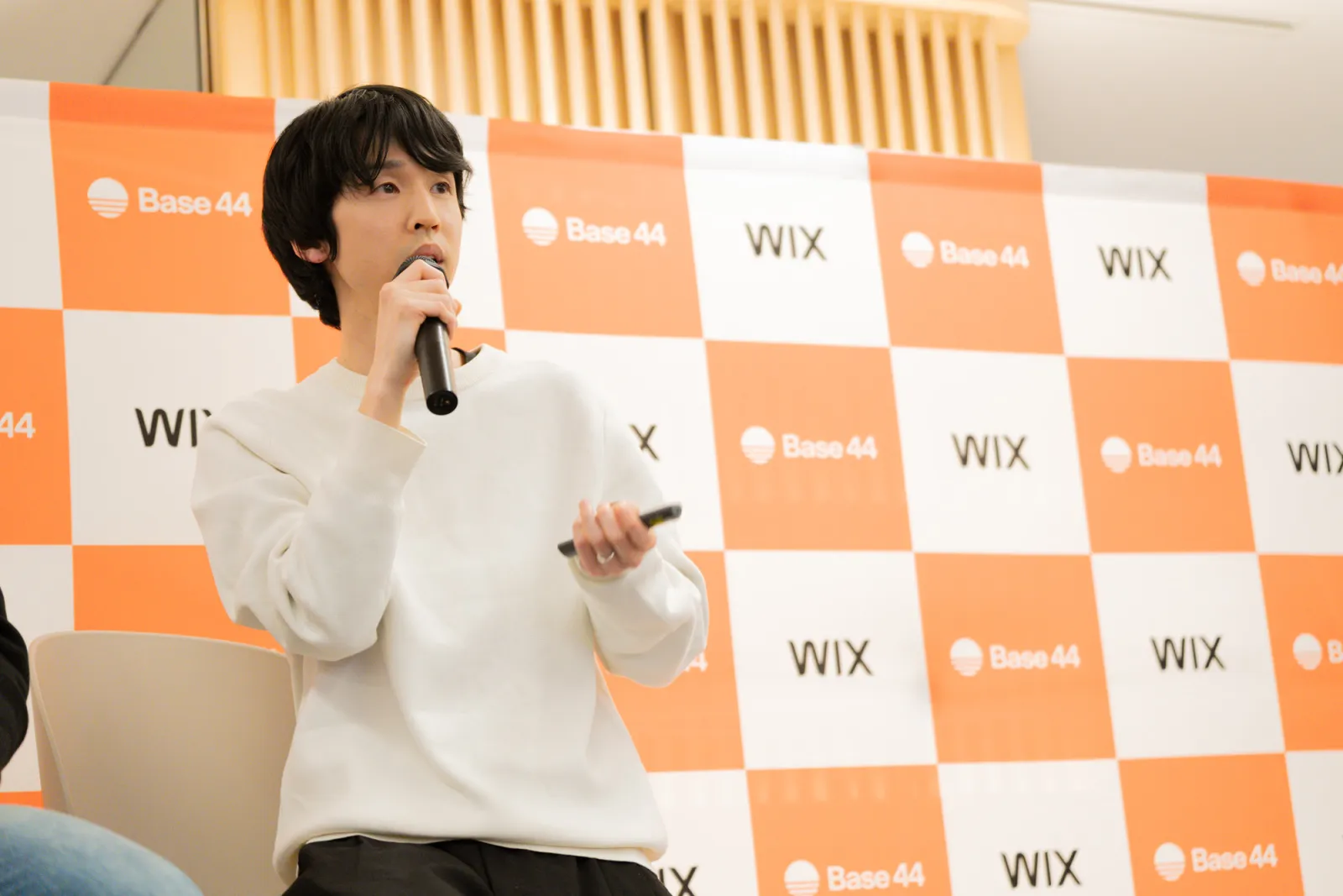 Base44イベントでマイクを持って登壇する川合卓也